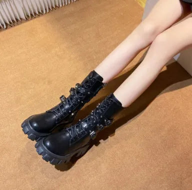 Women's black mid-calf knight boots with a large metal buckle and side zip fastening