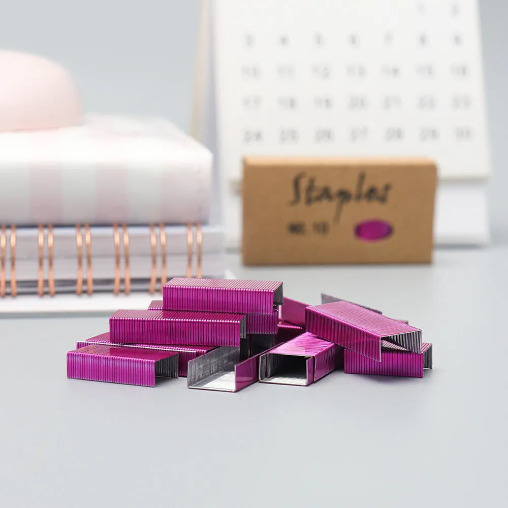 A box of 1000 metal office staples available in black, purple, rose gold, and rose red colours.