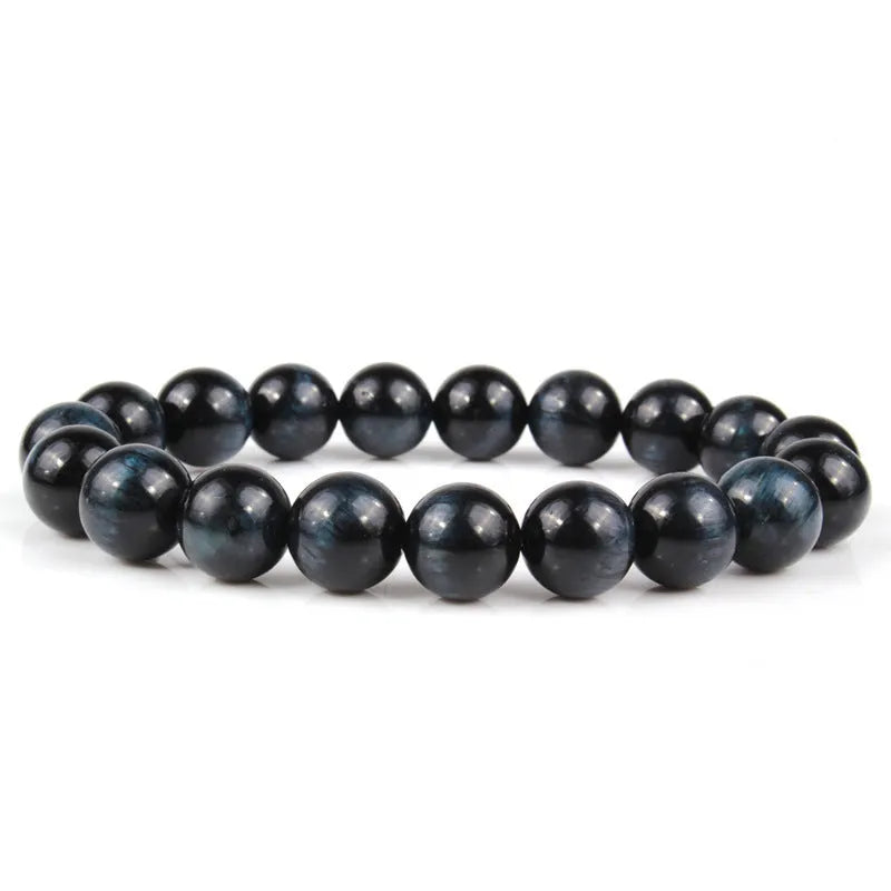 Natural tigereye crystal beaded bracelet with round beads, shown in a selection of colours and sizes on a wrist.