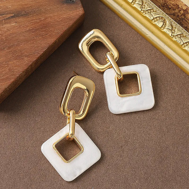 Hollow geometric square earrings with chamfered edges in electroplated copper