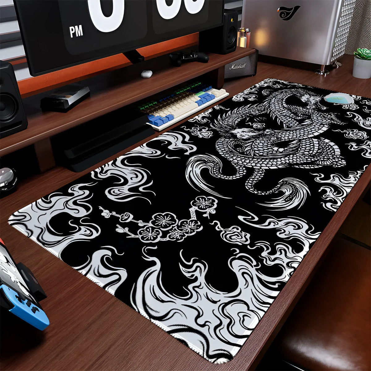 Large black cloth gaming mouse pad with detailed red and gold floral dragon artwork, showing non-slip base.