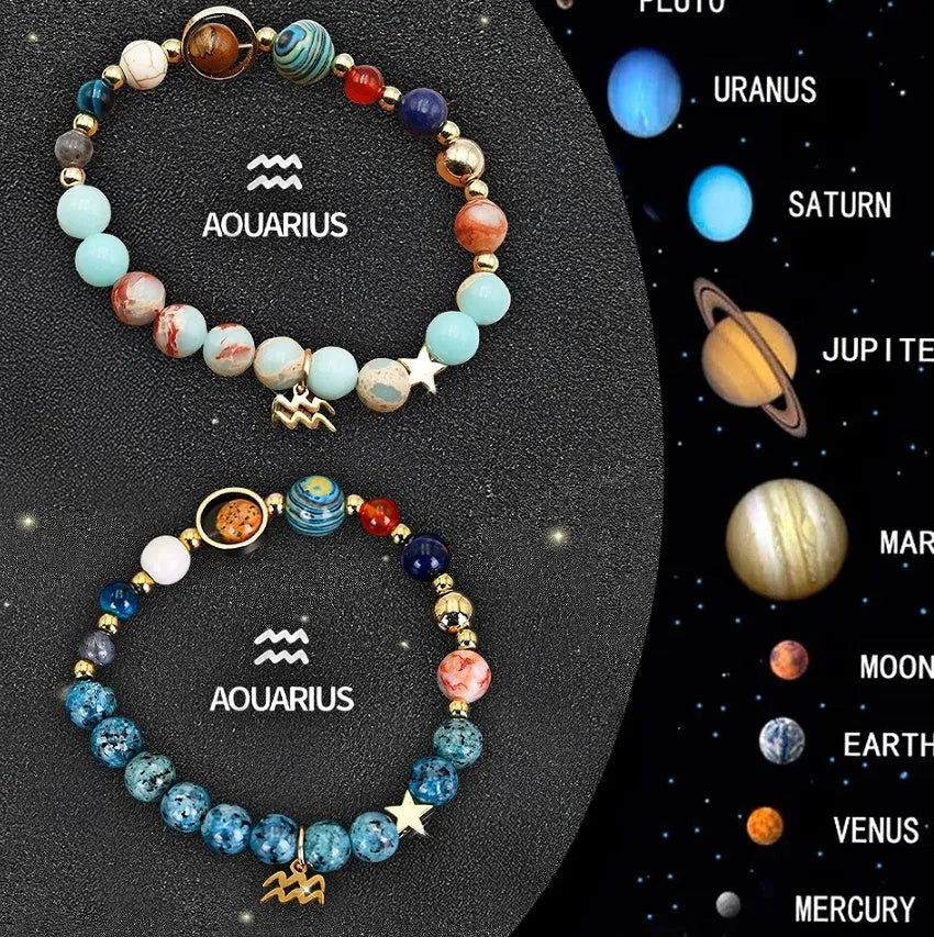 Set of two natural stone beaded bracelets with zodiac sign designs on a wooden surface.