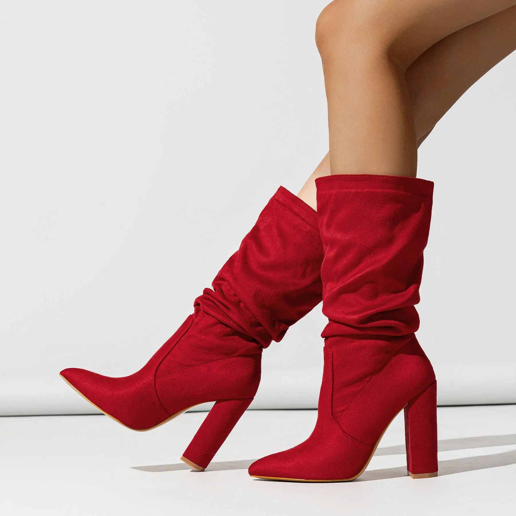 Women's black suede chunky heel boots with pointed toe and mid-calf shaft.