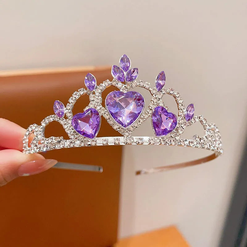 Close-up of a children's metal hairband headdress with a crown pattern in a light purple crystal colour.