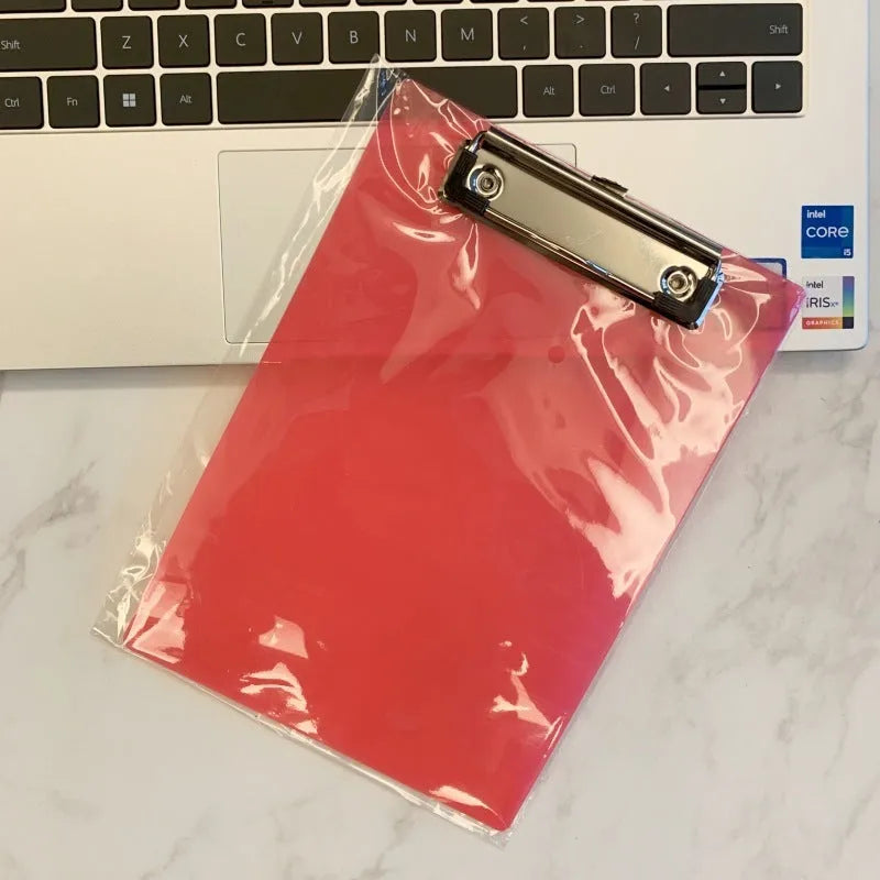 Transparent A4 clipboard with metal flat clip holding paper, shown in blue colour option.