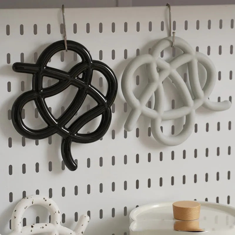Ceramic heat proof mat in irregular shape on a wooden table