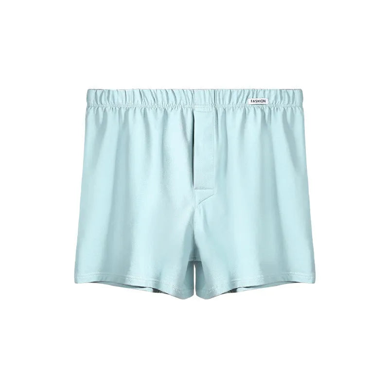Men's loose-fitting cotton boxer shorts in gold, green, sea blue, and light grey on a mid-waist mannequin.