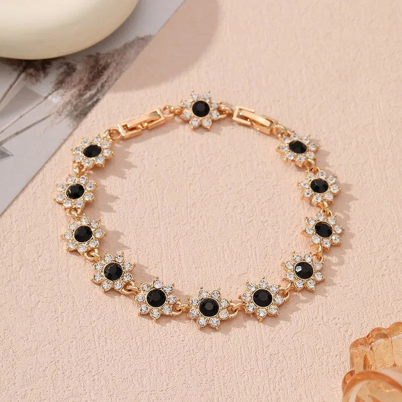 Floral coloured gemstone bracelet in zinc alloy with electroplated gold and silver crystal finishes.
