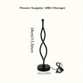 Black aluminum desk lamp with a touch dimming base on a wooden desktop.