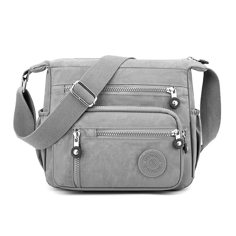 Grey soft nylon messenger bag with single adjustable shoulder strap showing square vertical shape