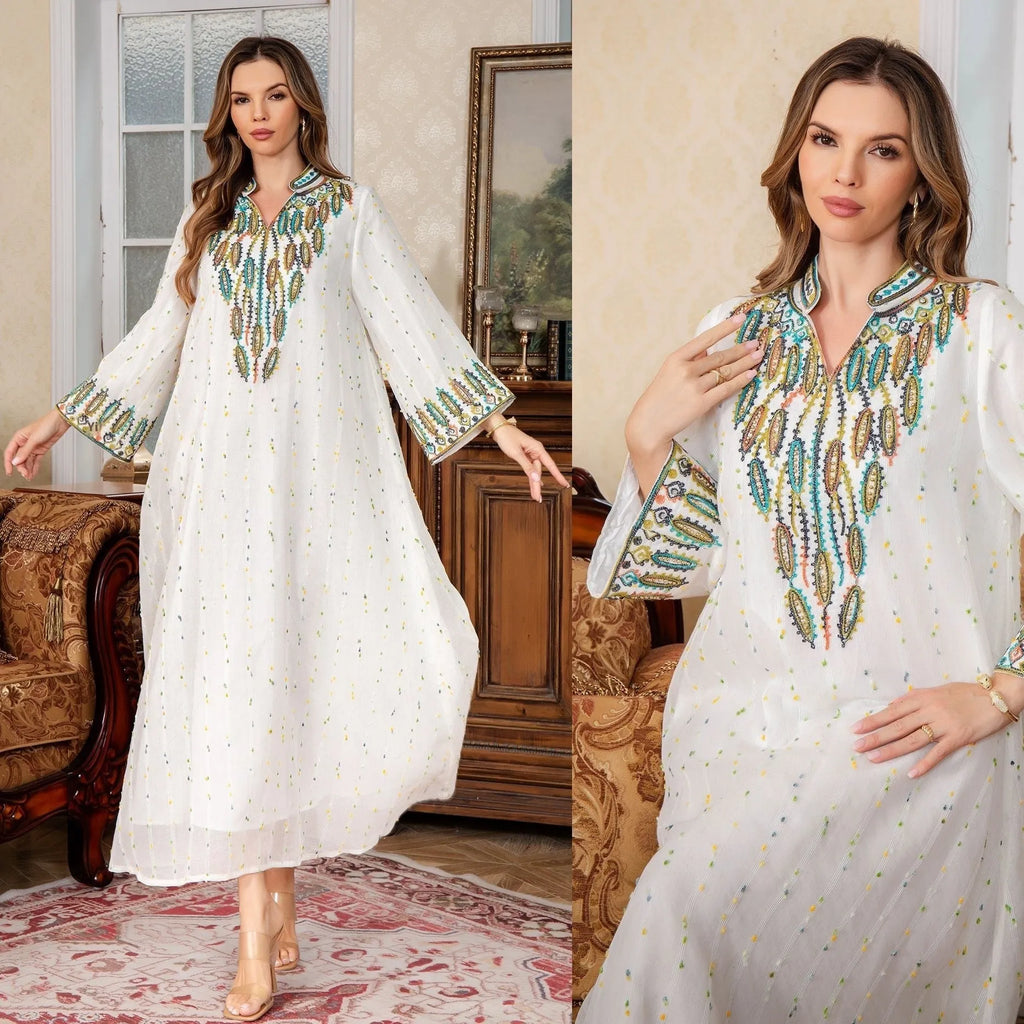 White floor-length Arabic robe with long sleeves on a hanger.