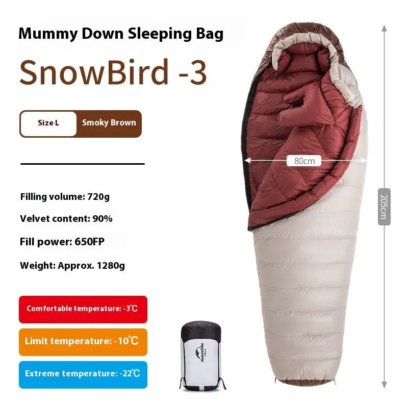 Mummy style goose down sleeping bag for adults shown with its storage bag