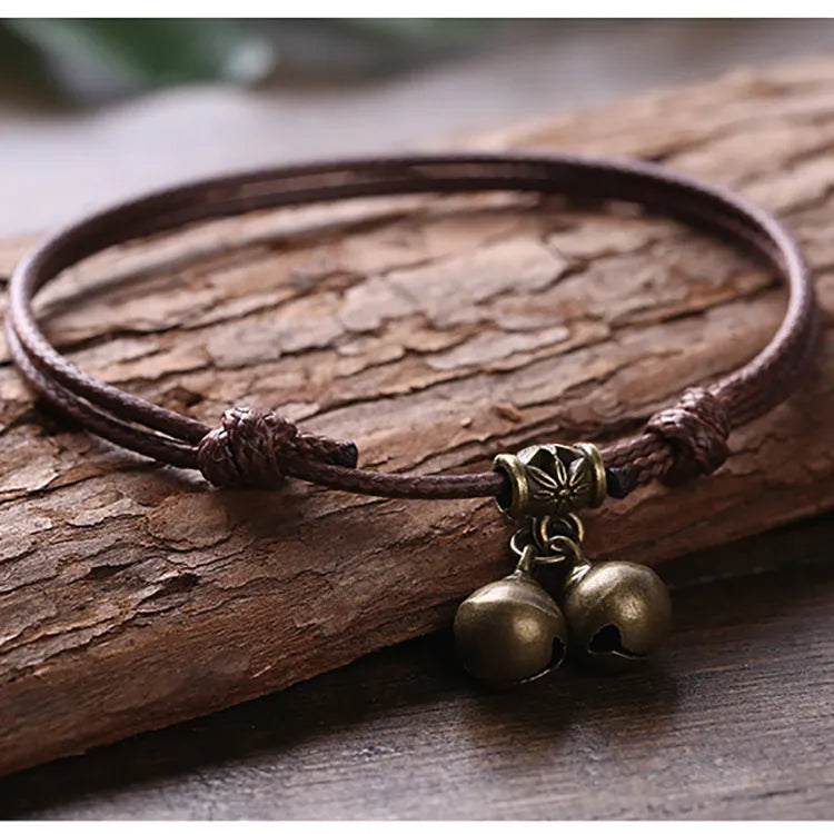 Adjustable nylon dog collar with brass bell on black rope, shown alongside red and coffee colour options.