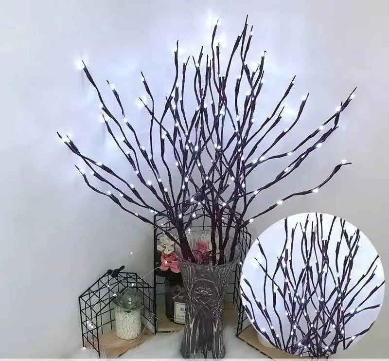 LED decorative tree light with silver branches in a vase, emitting coloured light.