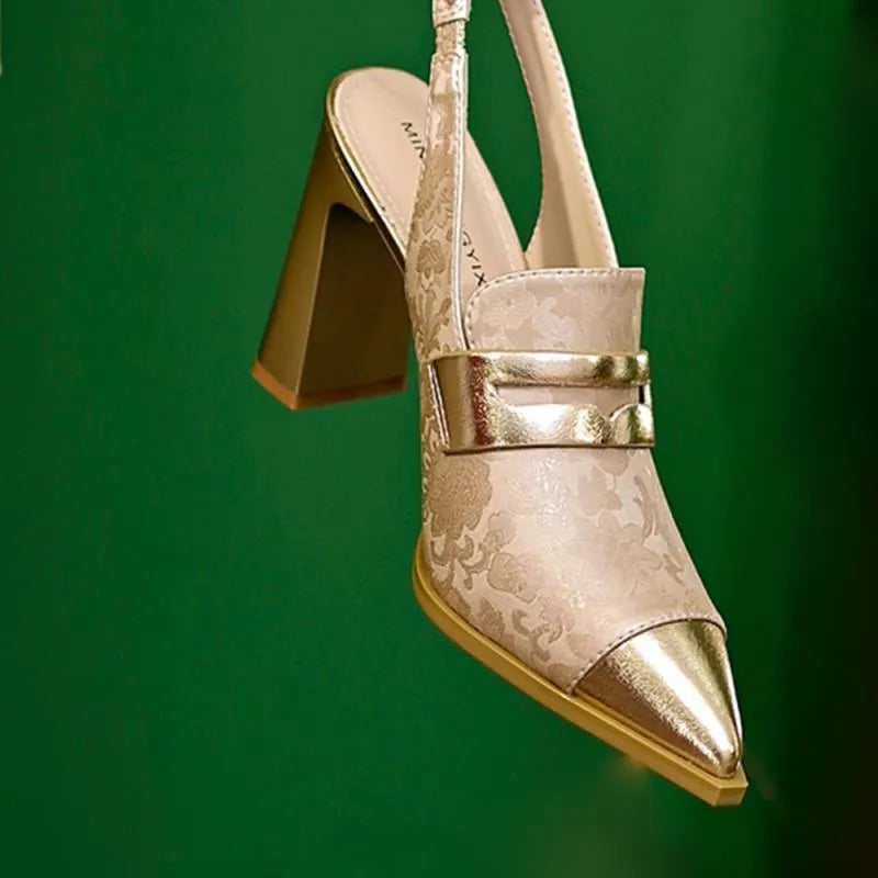 Black women's high-heel sandals with a chunky heel, pointed toe, and a single elasticated ankle strap.