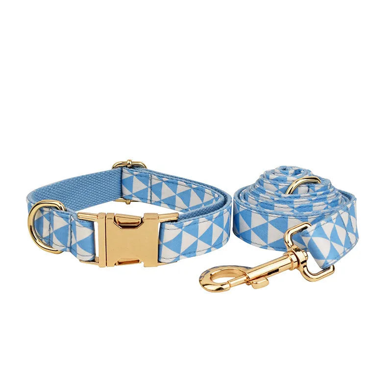 Blue cloth dog collar, leash, vest, and decorative bow four-piece pet accessory set.
