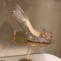 Women's gold high heels with pointed toe, stiletto heel and rhinestone sequin decoration