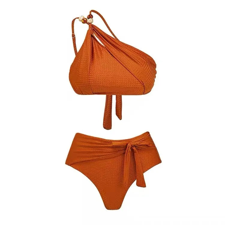 Women's brown push up bikini with high waist briefs and matching chiffon dress cover-up laid flat.