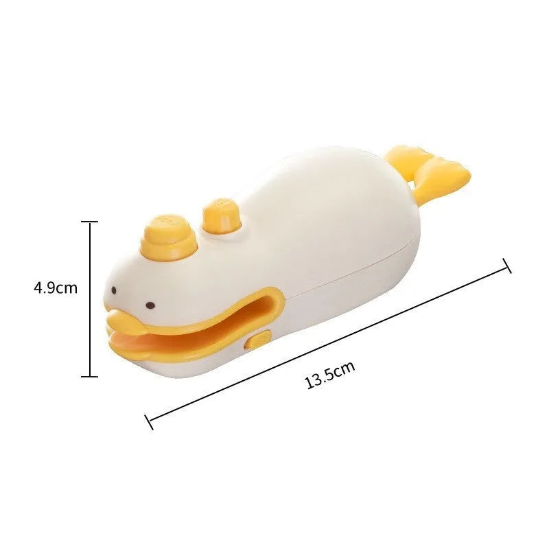 Small yellow duck-shaped rechargeable handheld sealing machine with USB charging cable.