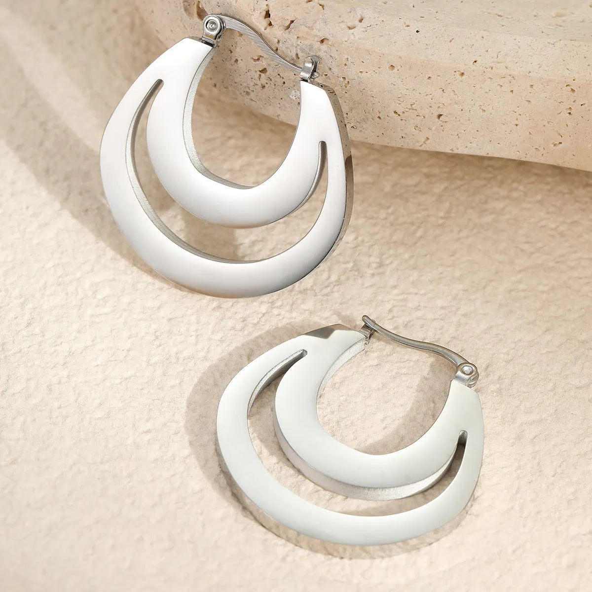 Geometric minimalist French earrings in gold or steel finish with round ring design elements