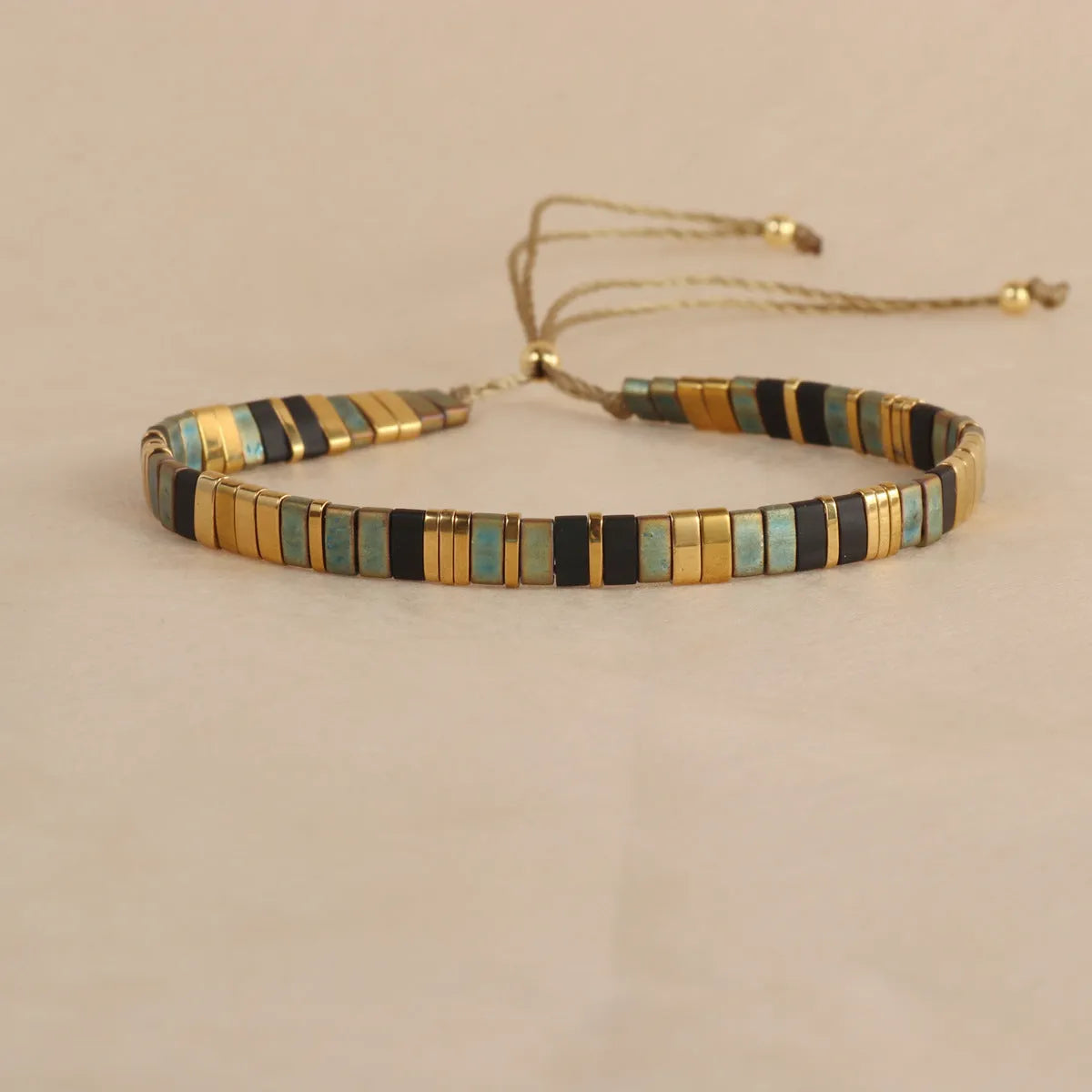 Geometric glass pull bead bracelet in milky white, black, green, blue or red with round decorative elements