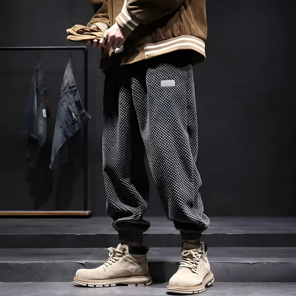 Men's grey ankle-tied straight-leg sweatpants laid flat, showing non-ironing casual design.