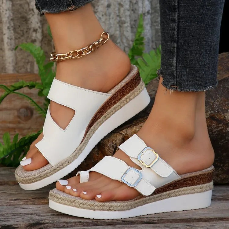 White patent leather wedge sandals with finger-fit design and woven detailing