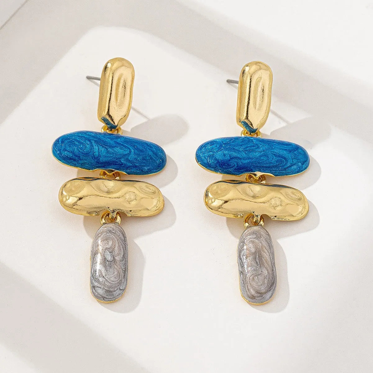 Geometric multicolor stud earrings for women with electroplated finish and simple design.