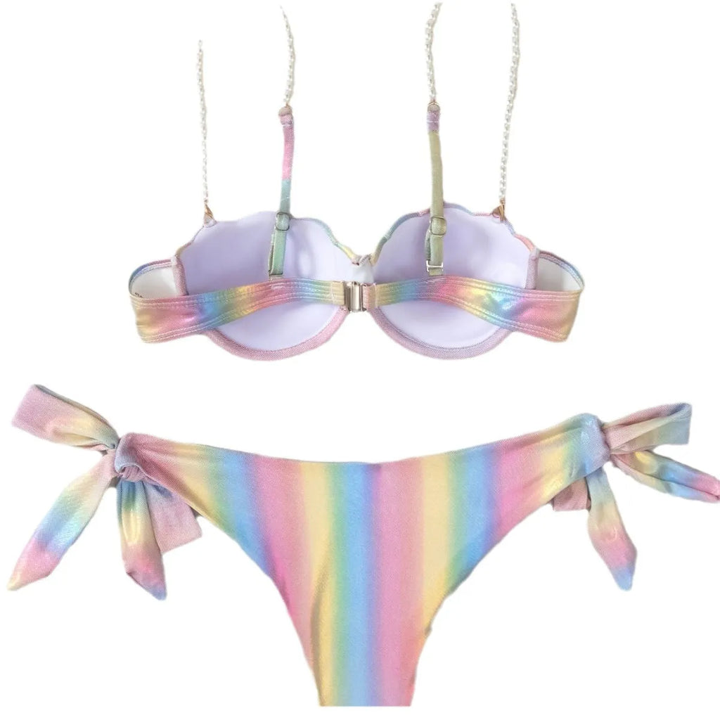 Women's rainbow tie dye bikini swimsuit with split tied sides on a model.