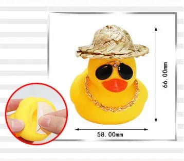Yellow duck car ornament wearing straw hat with removable sunglasses necklace on dashboard