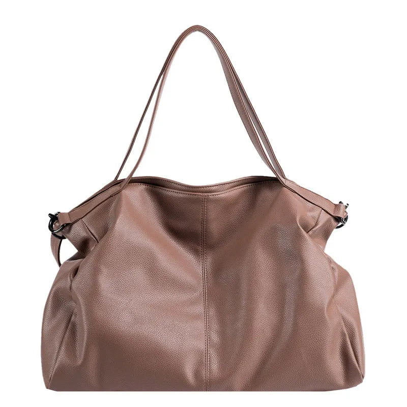 Large soft surface PU messenger bag in horizontal square shape with zip opening and shoulder strap.