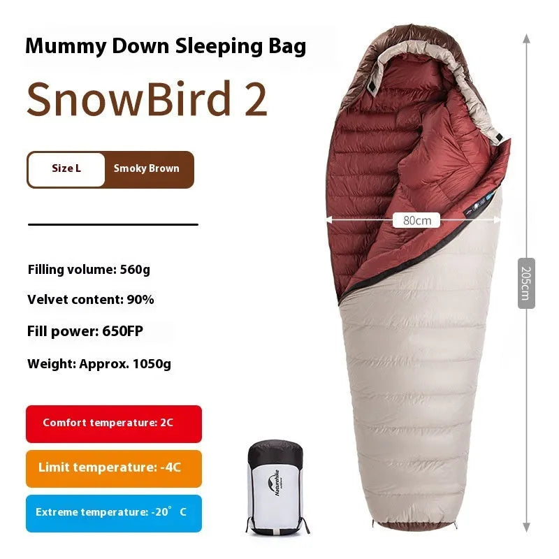Mummy style goose down sleeping bag for adults shown with its storage bag