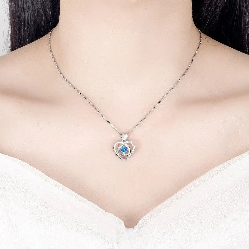 Blue diamond heart-shaped necklace and bracelet set with geometric pendant and mixed gem inlay on an adjustable copper chain.