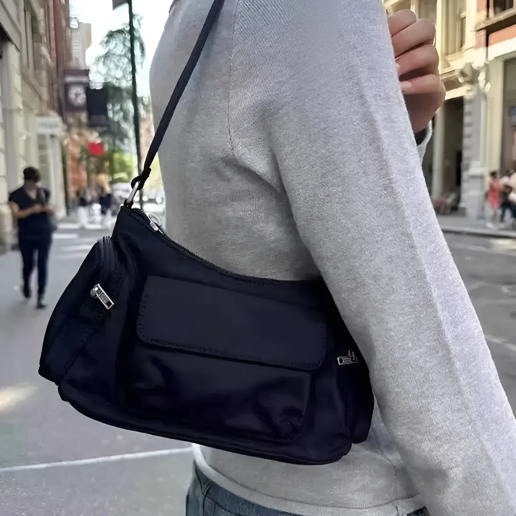 Simple black lightweight double pocket shoulder bag made of PU with side line detail.