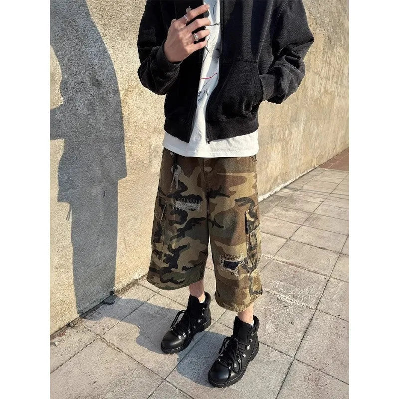Men's camouflage coloured cropped jeans with ripped detailing and retro patch accents