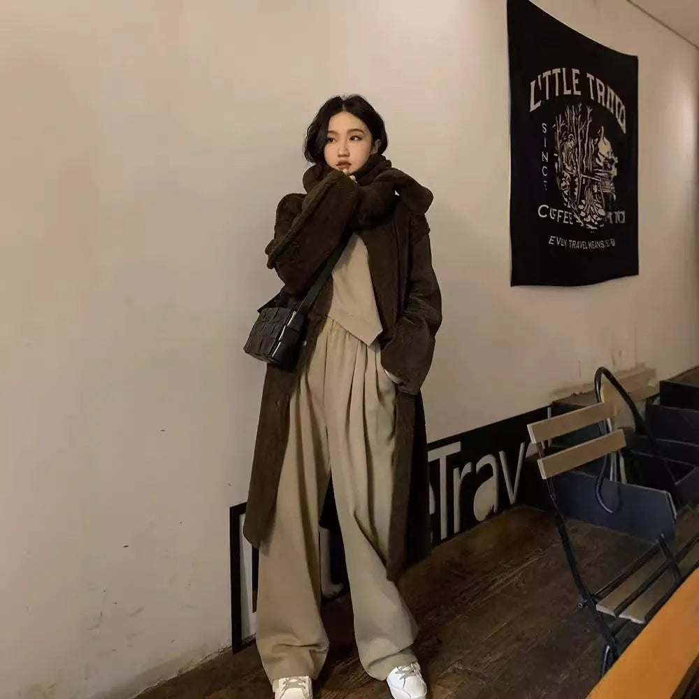Women's brown loose-fit casual sports suit with long sleeves and full-length trousers on a hanger.