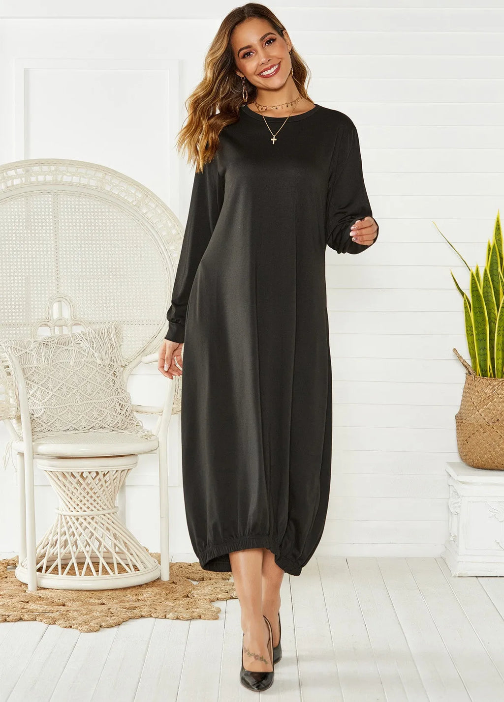 Black lace-up crew neck long lantern dress on a hanger, showing loose fit and lace detail.