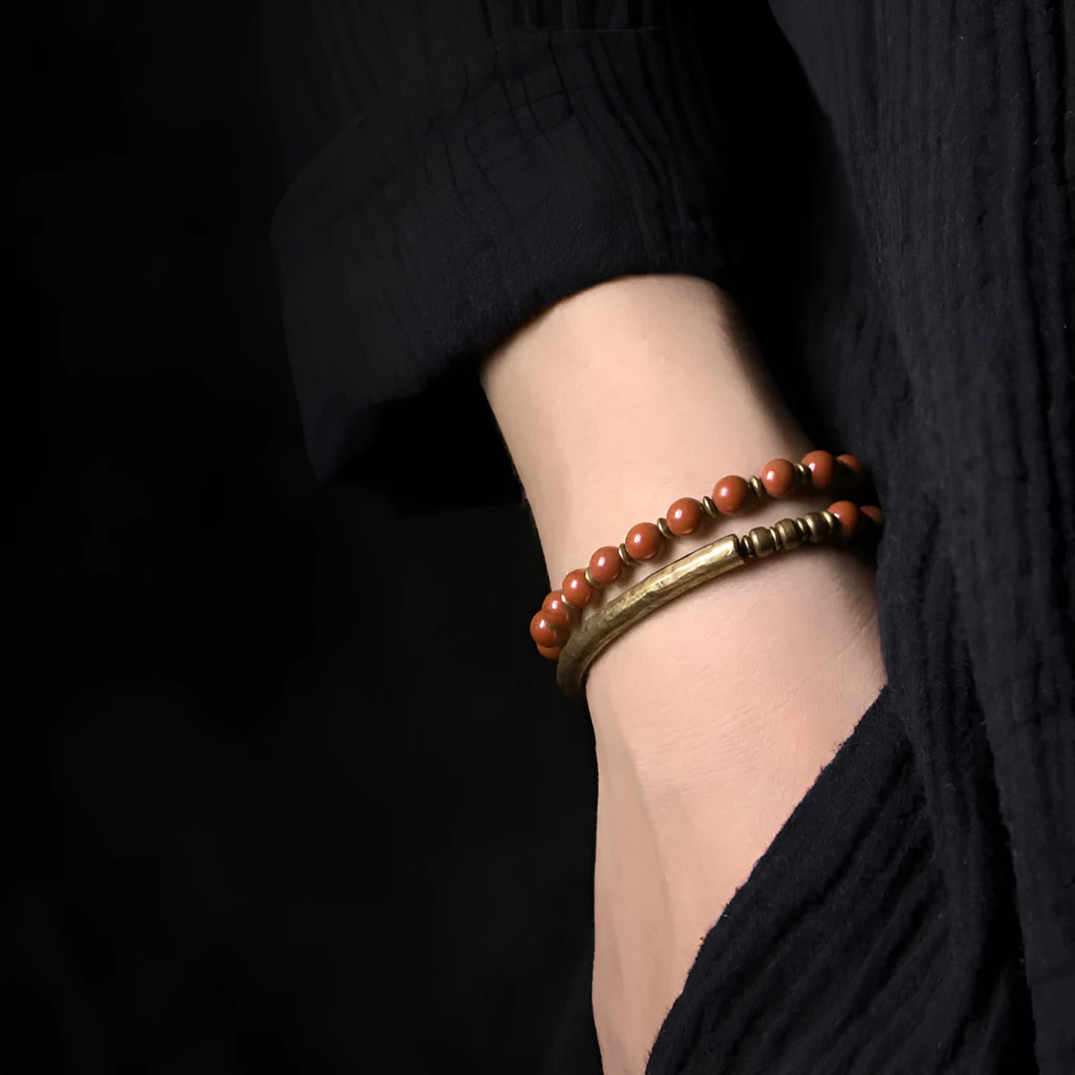 Layered ethnic bracelet in natural stone with brass detailing on wrist