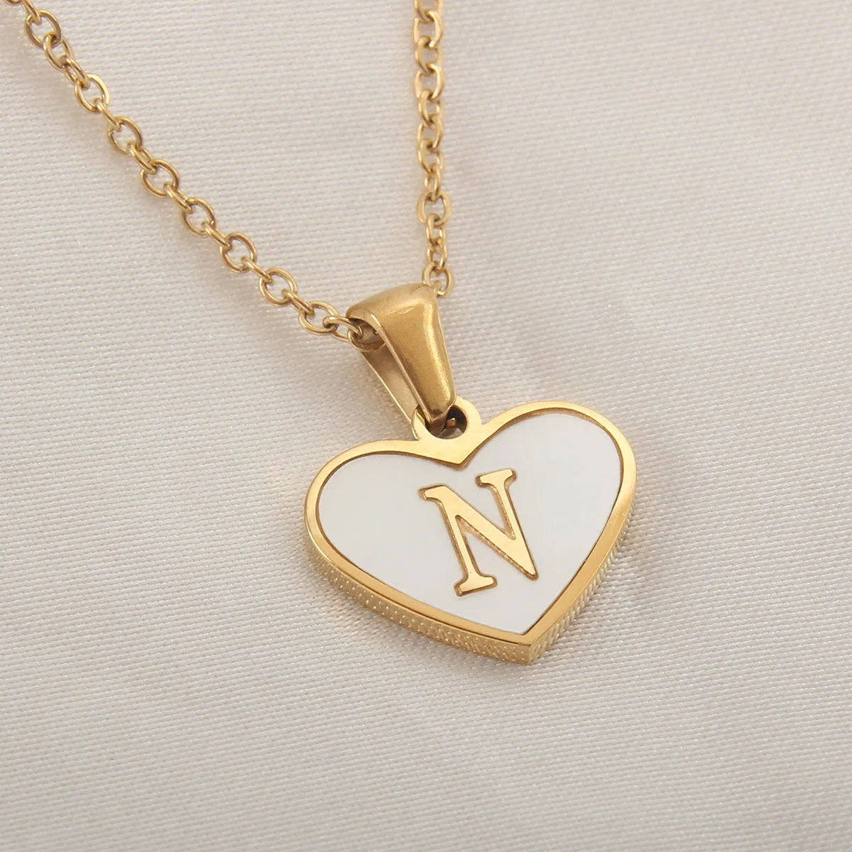 Gold plated initial necklace with white shell heart pendant and adjustable chain