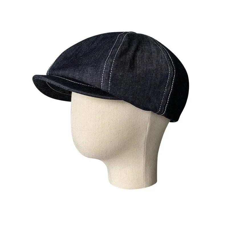 Black cotton retro-style beret for men and women on a plain background.