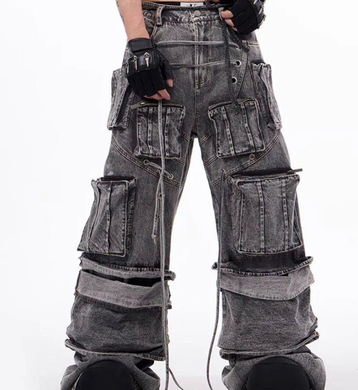 Grey distressed denim overalls with rope stitching on a hanger.