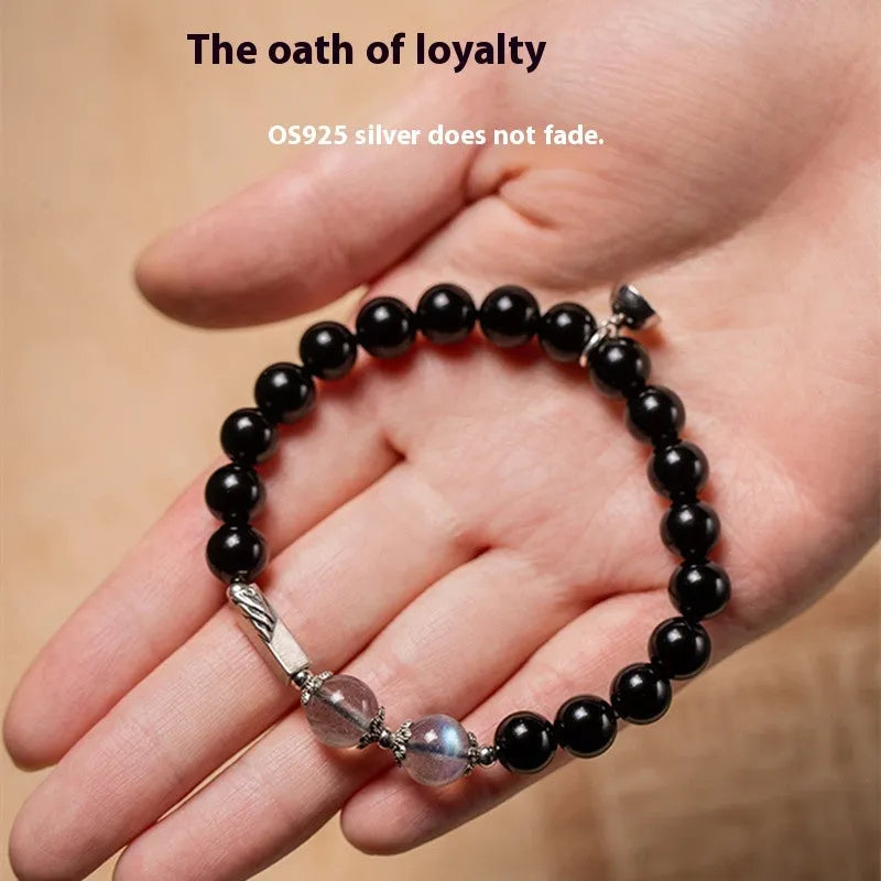 Obsidian Buddha beads couple bracelet set showing 8mm women's and 10mm men's sizing differences