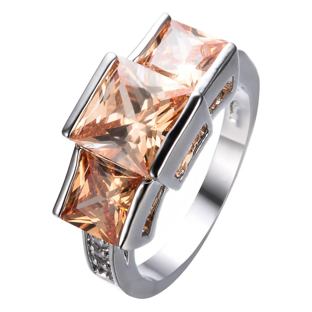 Women's copper electroplated ring in geometric design showing colour options including apple green and sapphire blue