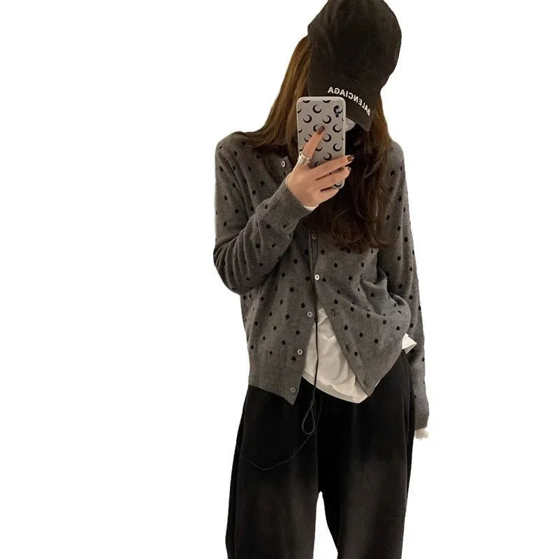 Women's grey dot knitted cardigan with long sleeves and crocheted flower detail
