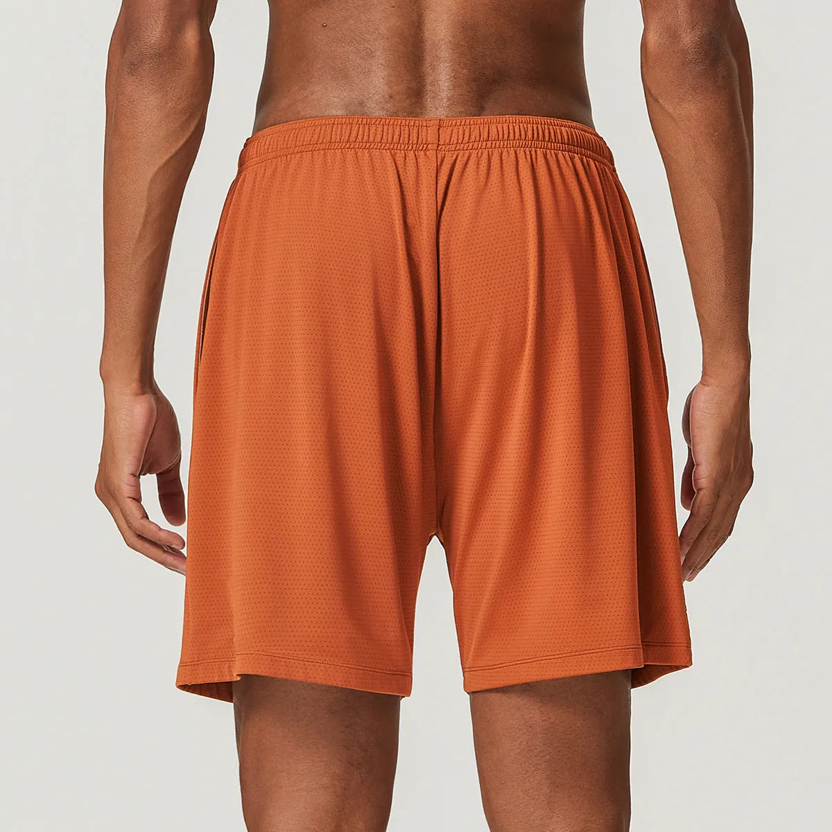 Men's quick-dry running shorts in brick red colour showing double-layer construction