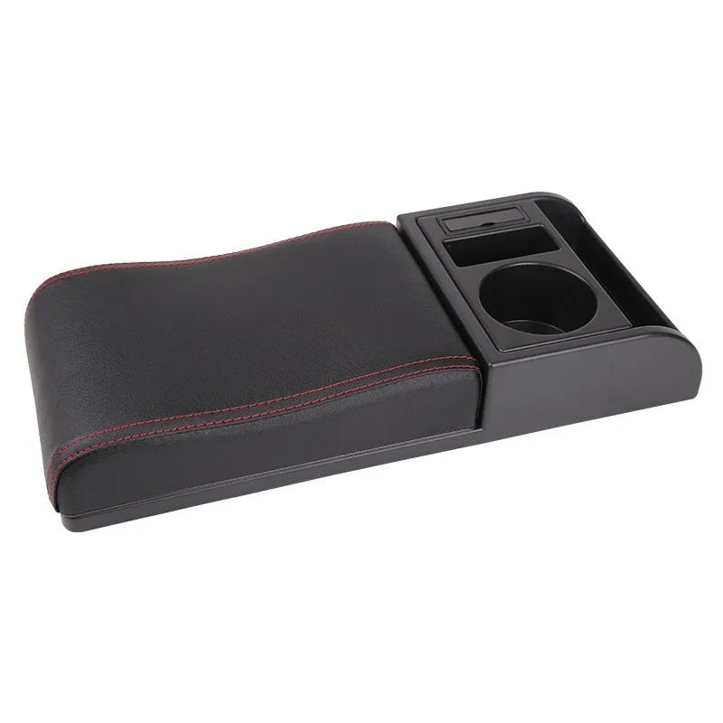 Universal plastic car armrest cover in black with red cord stitching on a centre console