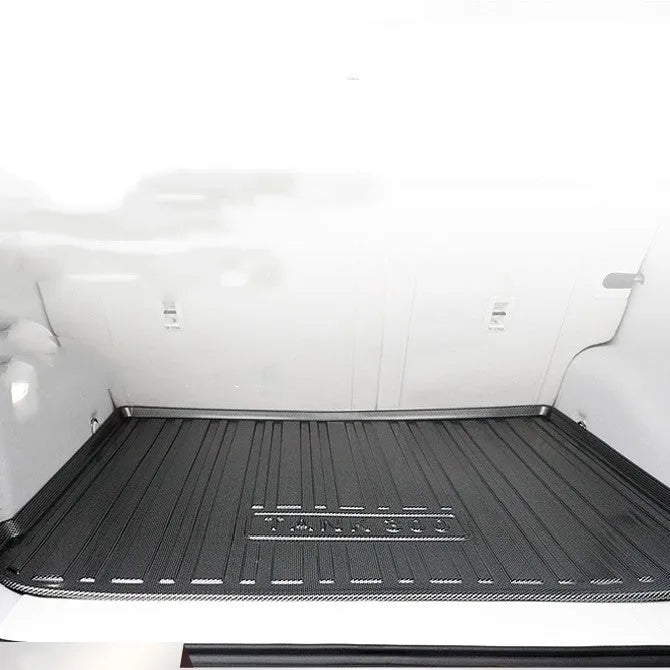 Black TPE car boot liner with a carbon fibre texture pattern laid flat.