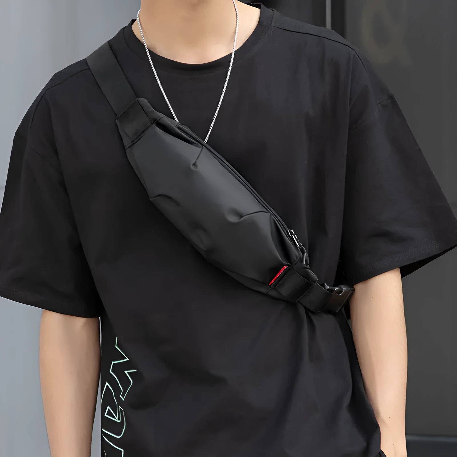 Black oxford cloth tactical crossbody bag showing front zipper and compact size.