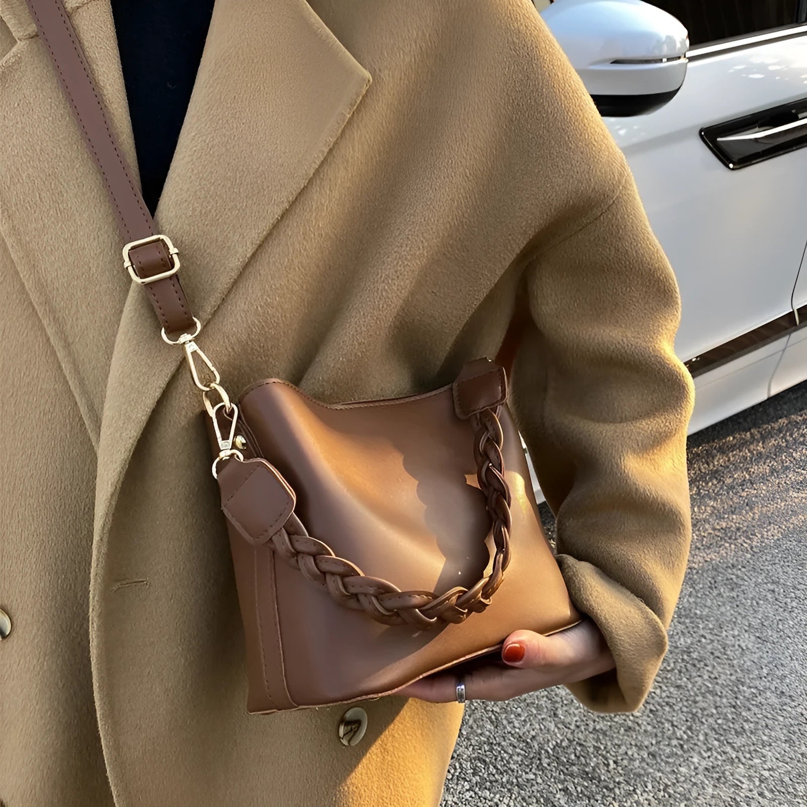 Woven texture PU leather crossbody bucket bag in neutral colour showing one-shoulder underarm carrying design
