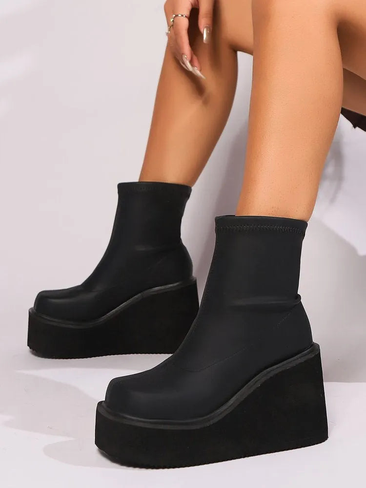 Black women's wedge ankle boots with waterproof platform in extended sizes